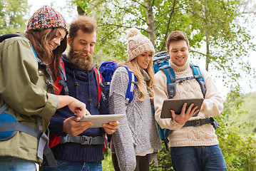 Image showing group of friends with backpacks and tablet pc