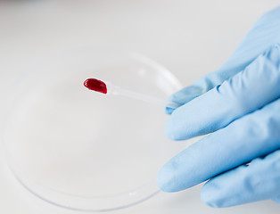 Image showing close up of scientist with blood sample in lab