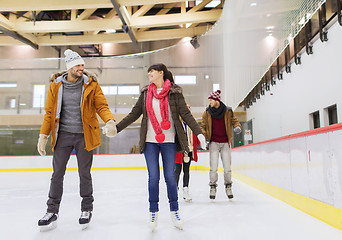 Image showing happy friends on skating rink