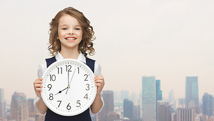 Image showing smiling girl holding big clock