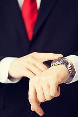 Image showing man looking at wristwatch