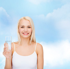 Image showing young smiling woman with glass of water