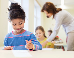 Image showing happy little school girl over classroom background