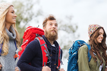 Image showing group of smiling friends with backpacks hiking