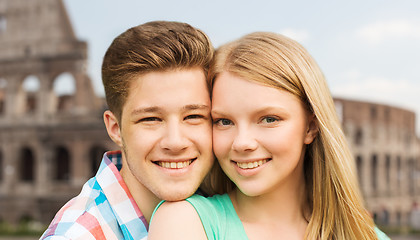 Image showing smiling couple over coliseum background