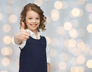 Image showing happy little school girl showing thumbs up