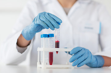 Image showing close up of scientist with tube making test in lab