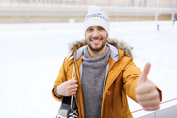 Image showing happy young man showing thumbs up on skating rink