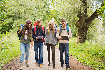 Image showing group of friends with backpacks and tablet pc