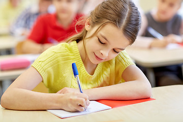 Image showing group of school kids writing test in classroom