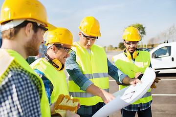 Image showing group of builders with tablet pc and blueprint