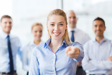 Image showing smiling businesswoman pointing finger on you