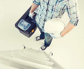 Image showing man with ladder, helmet and toolkit