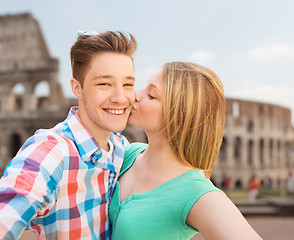 Image showing couple kissing and taking selfie over coliseum