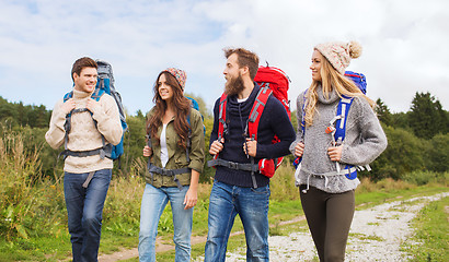 Image showing group of smiling friends with backpacks hiking