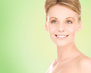 Image showing close up of smiling woman over green background