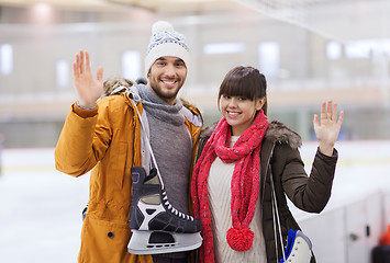 Image showing happy couple with ice-skates on skating rink