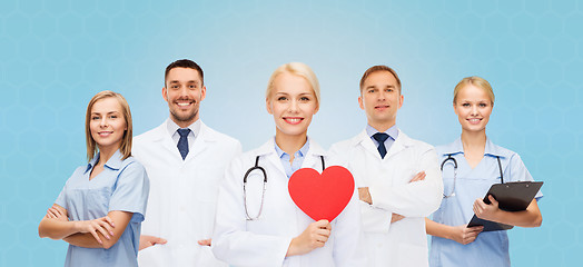 Image showing group of smiling doctors with red heart shape