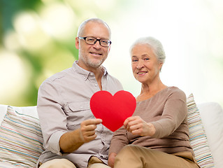 Image showing happy senior couple with red heart shape