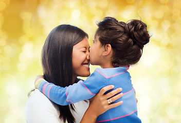 Image showing happy little girl hugging and kissing her mother