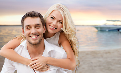 Image showing happy couple having fun over beach background