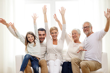 Image showing happy family sitting on sofa at home