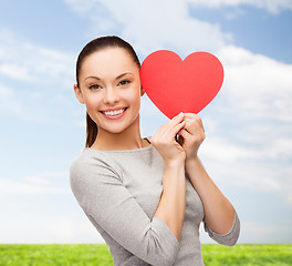 Image showing smiling asian woman with red heart