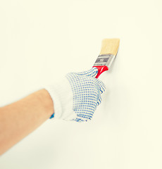 Image showing hand coloring wall with paintbrush