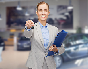 Image showing businesswoman or saleswoman giving car key