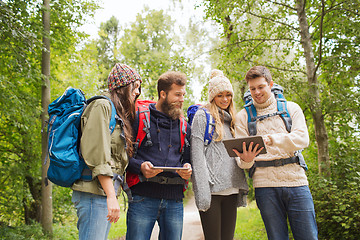 Image showing group of friends with backpacks and tablet pc