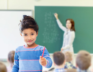 Image showing happy little school girl over classroom background