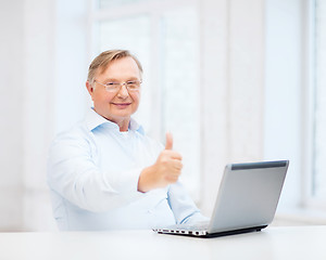 Image showing old man with laptop computer showing thumbs up