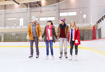 Image showing happy friends on skating rink