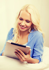 Image showing smiling woman with tablet pc computer at home