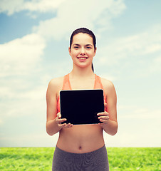 Image showing sporty woman with tablet pc blank screen