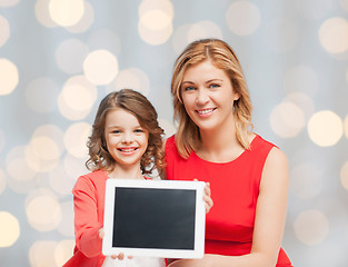 Image showing mother and daughter with tablet pc over green