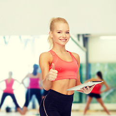 Image showing smiling sporty woman with tablet pc computer