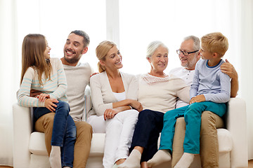 Image showing happy family sitting on couch at home