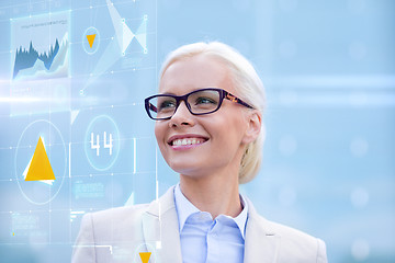 Image showing young smiling businesswoman in eyeglasses outdoors