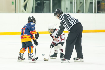 Image showing Puck playing between players of ice-hockey teams