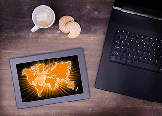 Image showing World map on a tablet