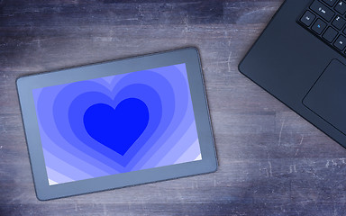 Image showing Heart shape backgound on tablet