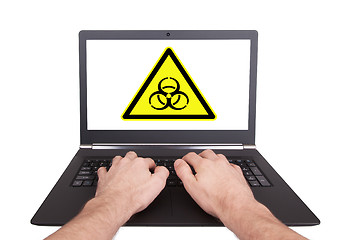 Image showing Man working on laptop, biohazard