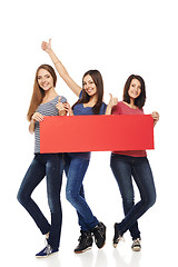 Image showing Three girl friends with red banner