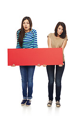 Image showing Two girl friends with red banner