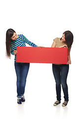 Image showing Two girl friends with red banner