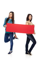 Image showing Two girl friends with red banner