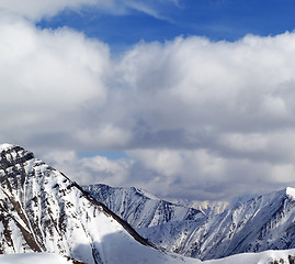 Image showing Winter snowy mountains in clouds at nice day