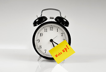 Image showing Alarm clock with a yellow note