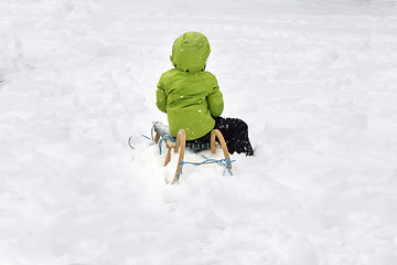 Image showing A child on sled